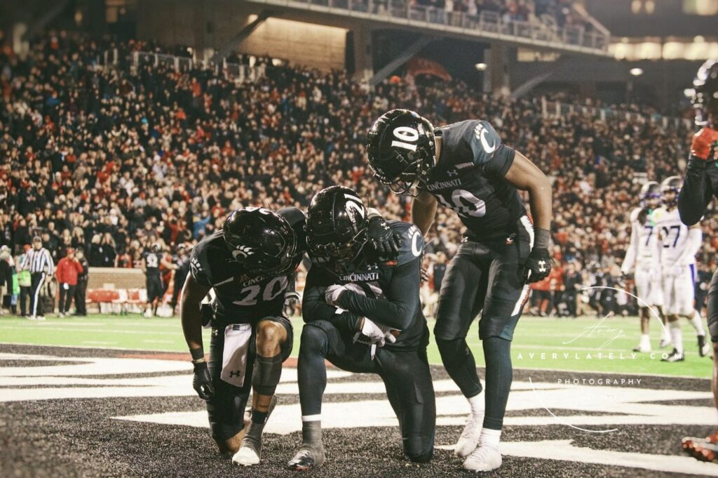 UC Bearcats Touchdown in Endzone by Linen & Elm Photography